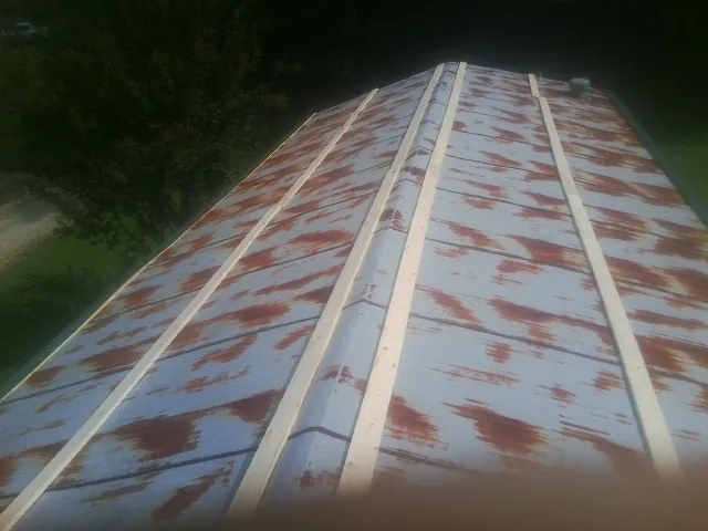 Rusted metal roof panels with new wood purlins before replacement — Storm Damage Roof Repair in Lehman by Roofing Brothers
