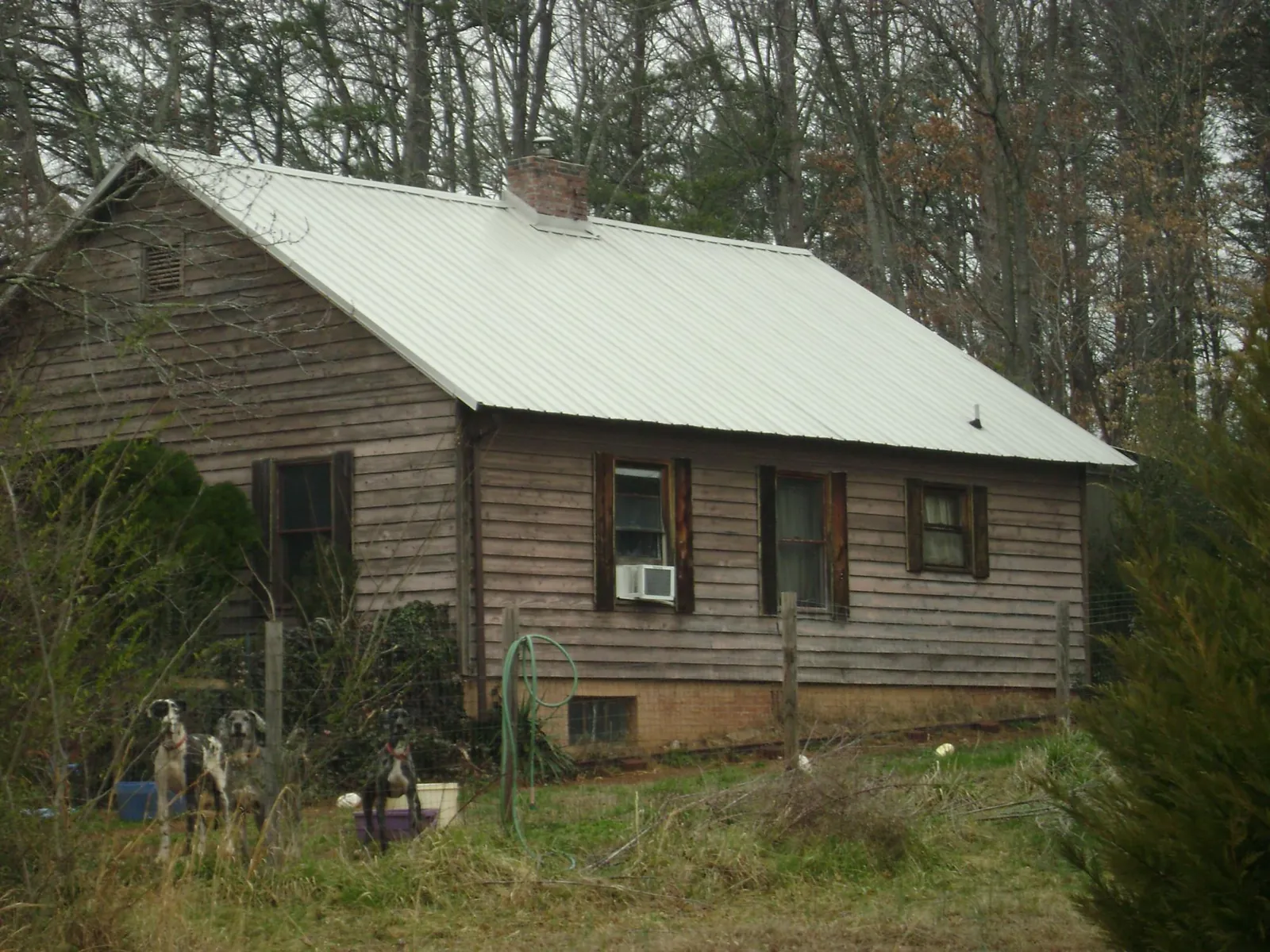 White metal roof on an old wood sided farmhouse, from a Metal Roof Installation job in Lehman